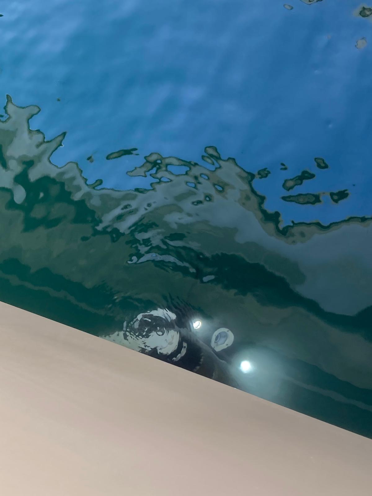 Underwater cleaning drone attached to a yacht hull
